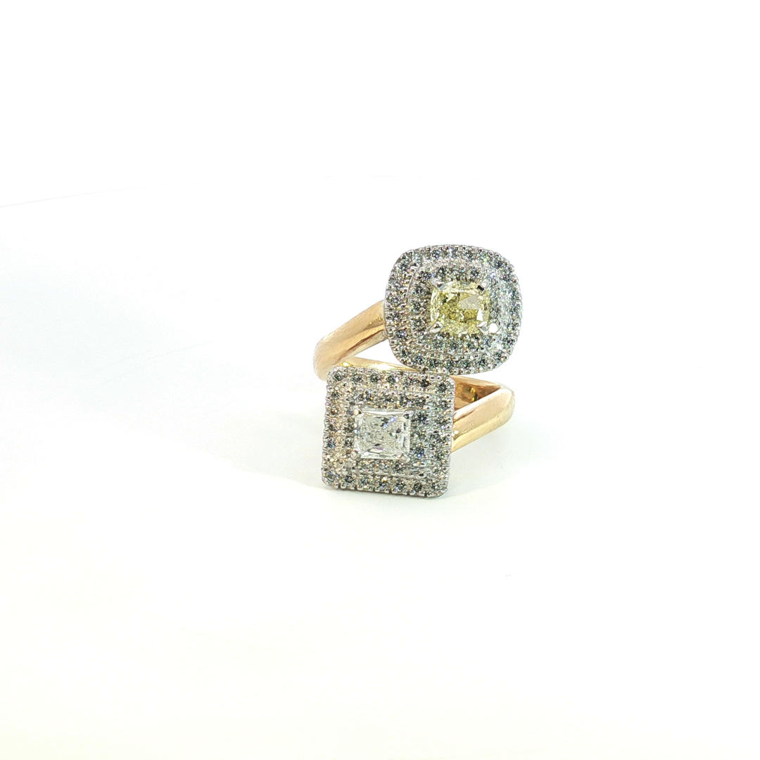 18ct yellow and white gold double cluster offset ring with a radiant cut white diamond and cushion cut yellow diamond